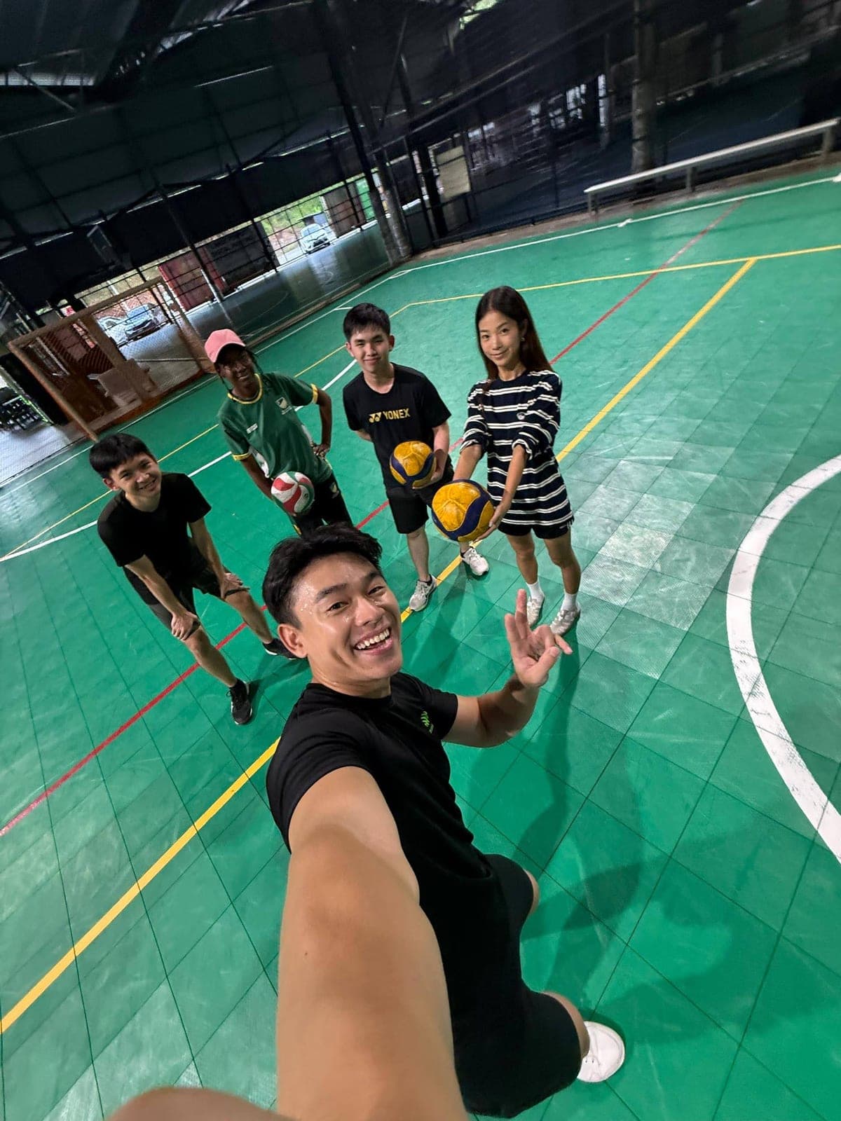 Sigmaschool team playing volleyball on an indoor court