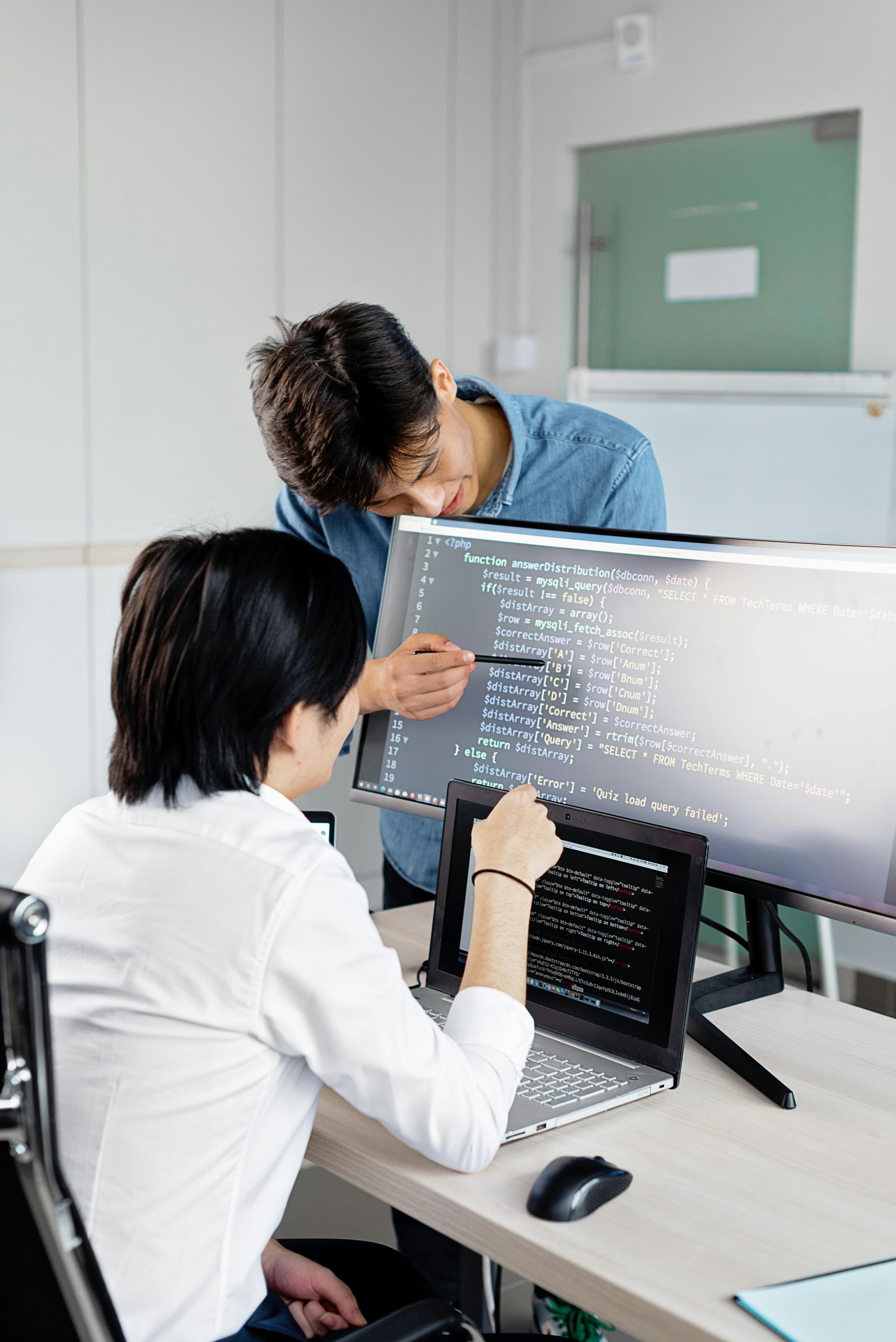 Two students coding together