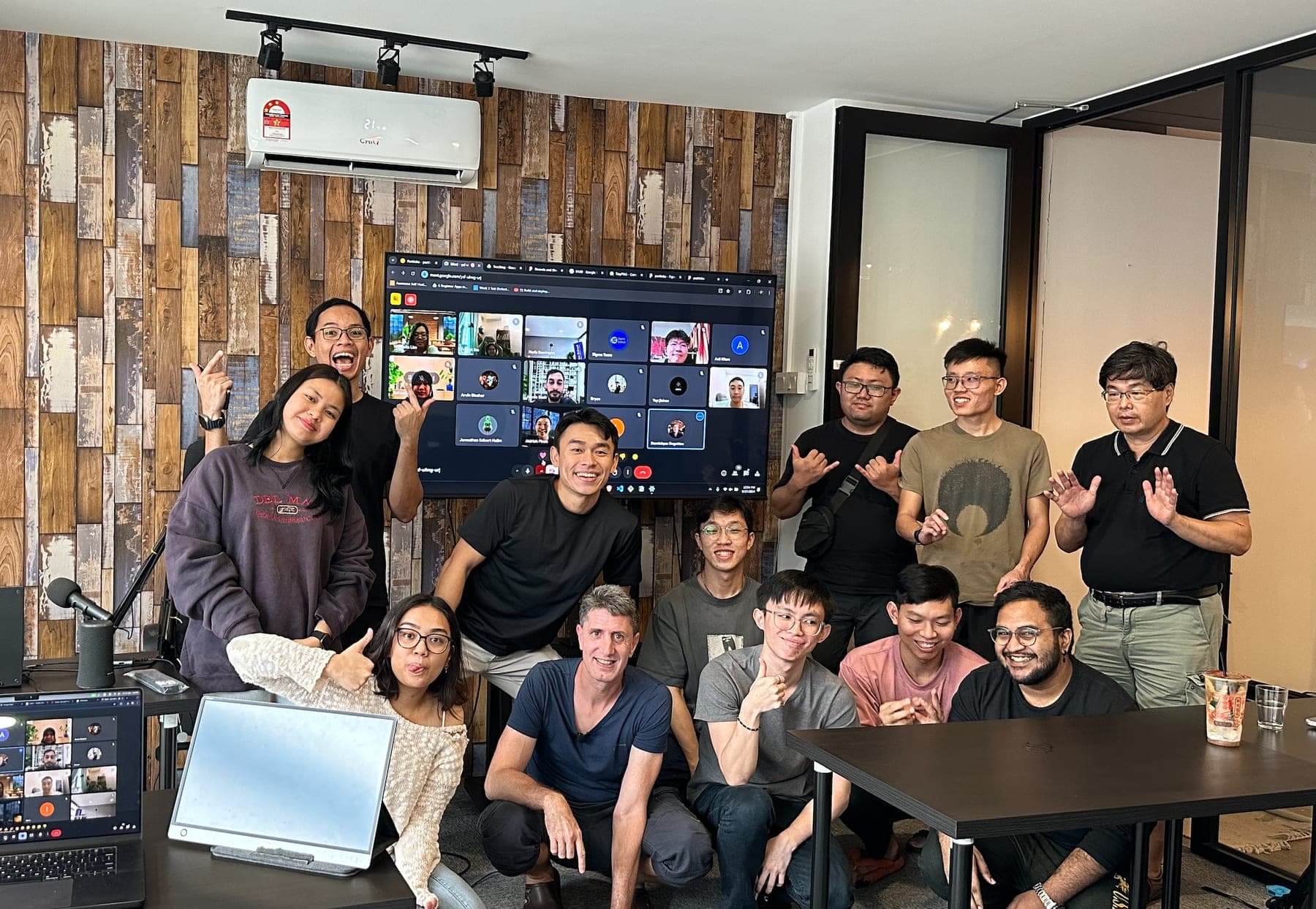Sigmaschool students building software together with the remote cohort on screen